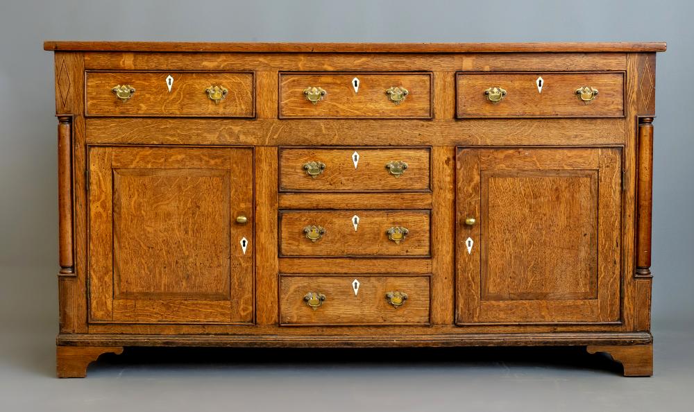 A GEORGIAN OAK AND MAHOGANY BANDED DRESSER Image