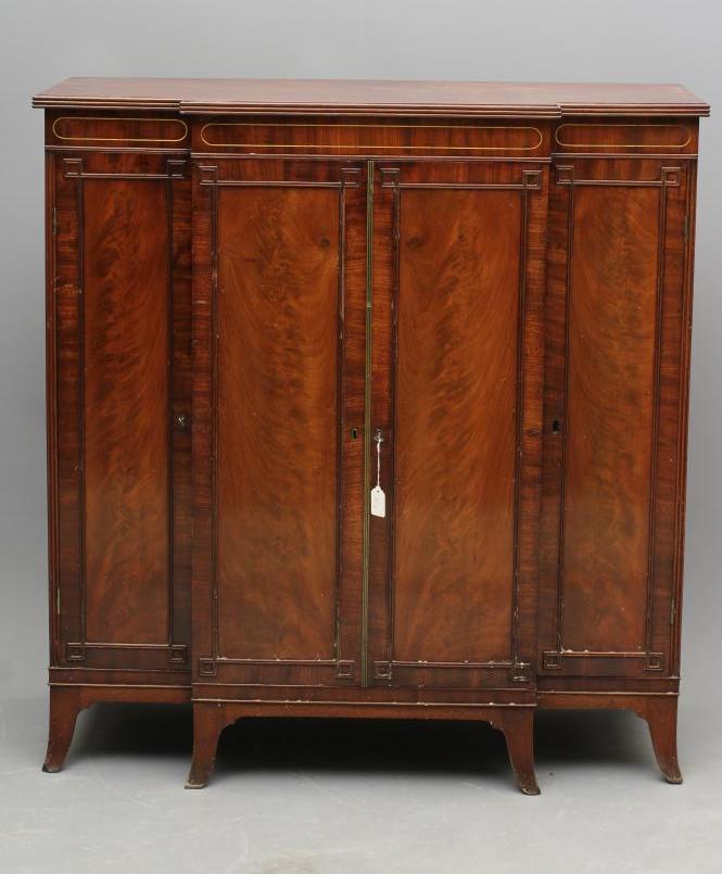 A REGENCY MAHOGANY SIDE CABINET of breakfront form with brass stringing Image