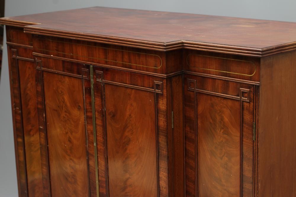 A REGENCY MAHOGANY SIDE CABINET of breakfront form with brass stringing Image