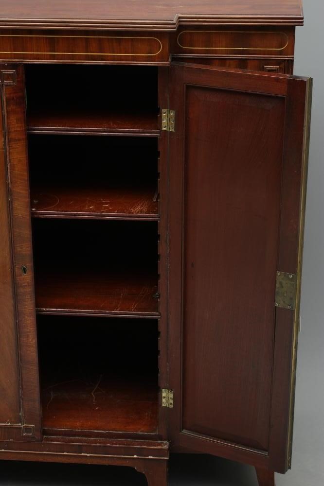A REGENCY MAHOGANY SIDE CABINET of breakfront form with brass stringing Image