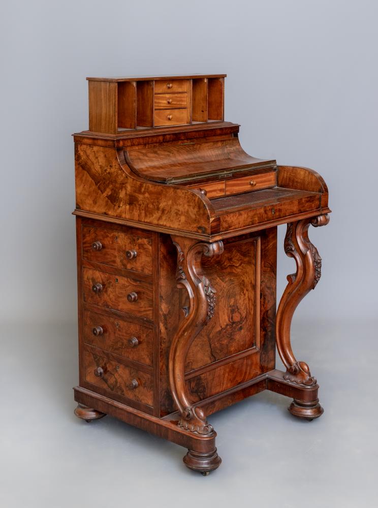 A VICTORIAN WALNUT PIANO TOP DAVENPORT with counter balanced elevating stationery compartment Image