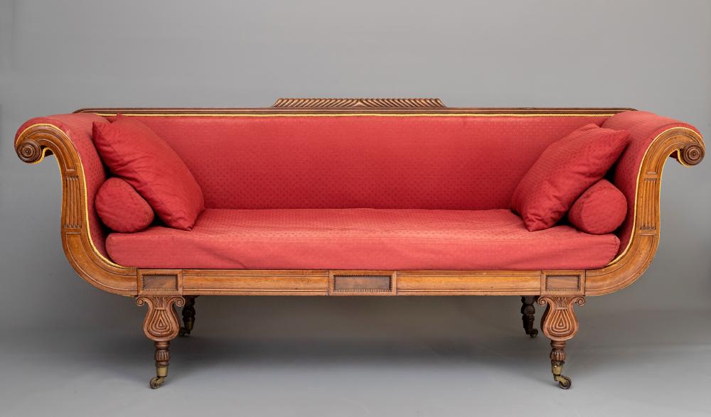 A REGENCY MAHOGANY SCROLL END SOFA upholstered in a red weave Image