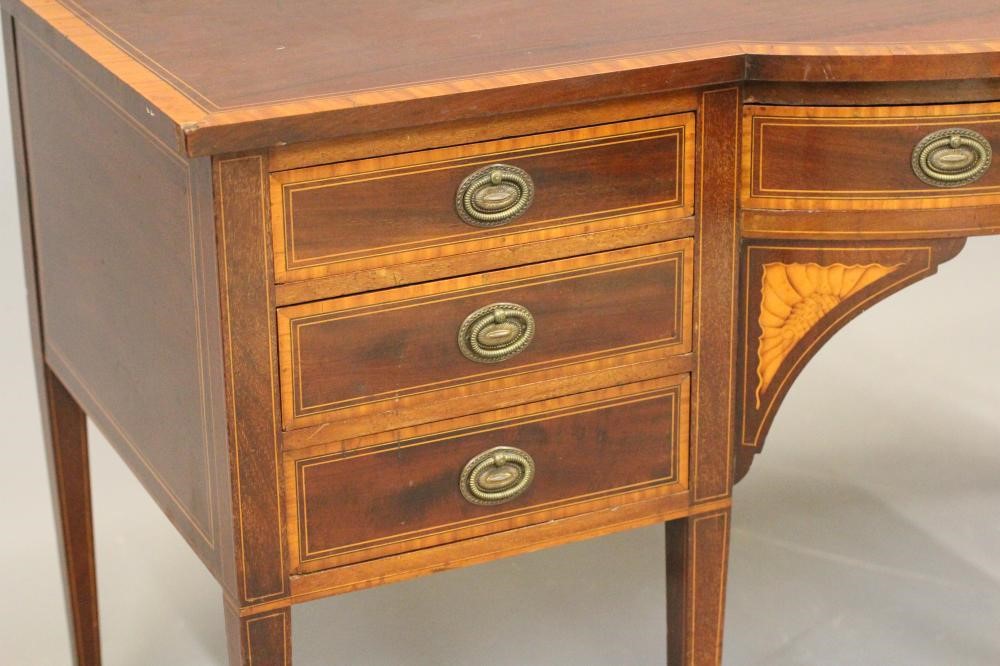 AN EDWARDIAN MAHOGANY AND SATINWOOD BANDED DESK with bowed centre section and stringing Image