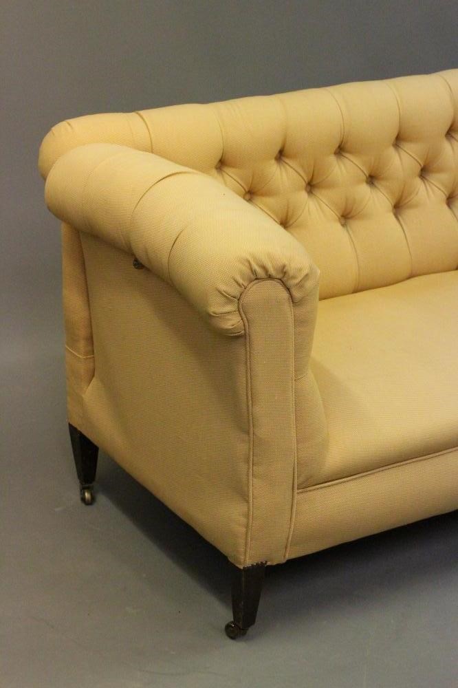 A LATE VICTORIAN MAHOGANY FRAMED DROP END SOFA of Chesterfield type Image