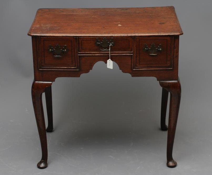 A GEORGE II OAK LOWBOY Image