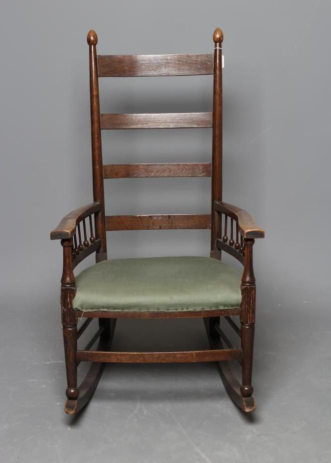 AN ARTS AND CRAFTS OAK ROCKING CHAIR Image