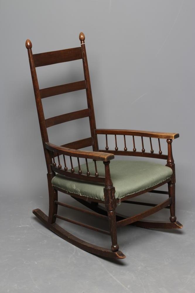 AN ARTS AND CRAFTS OAK ROCKING CHAIR Image