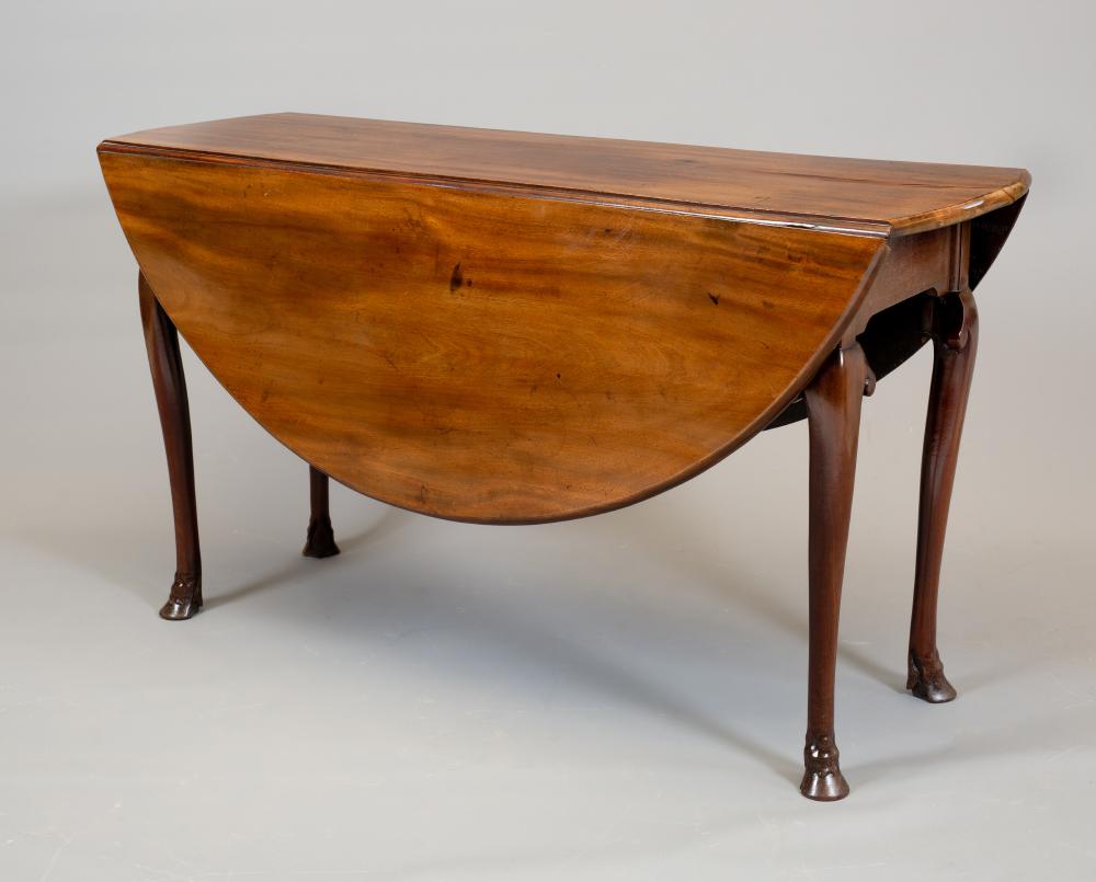 A GEORGE II MAHOGANY DROP LEAF DINING TABLE Image