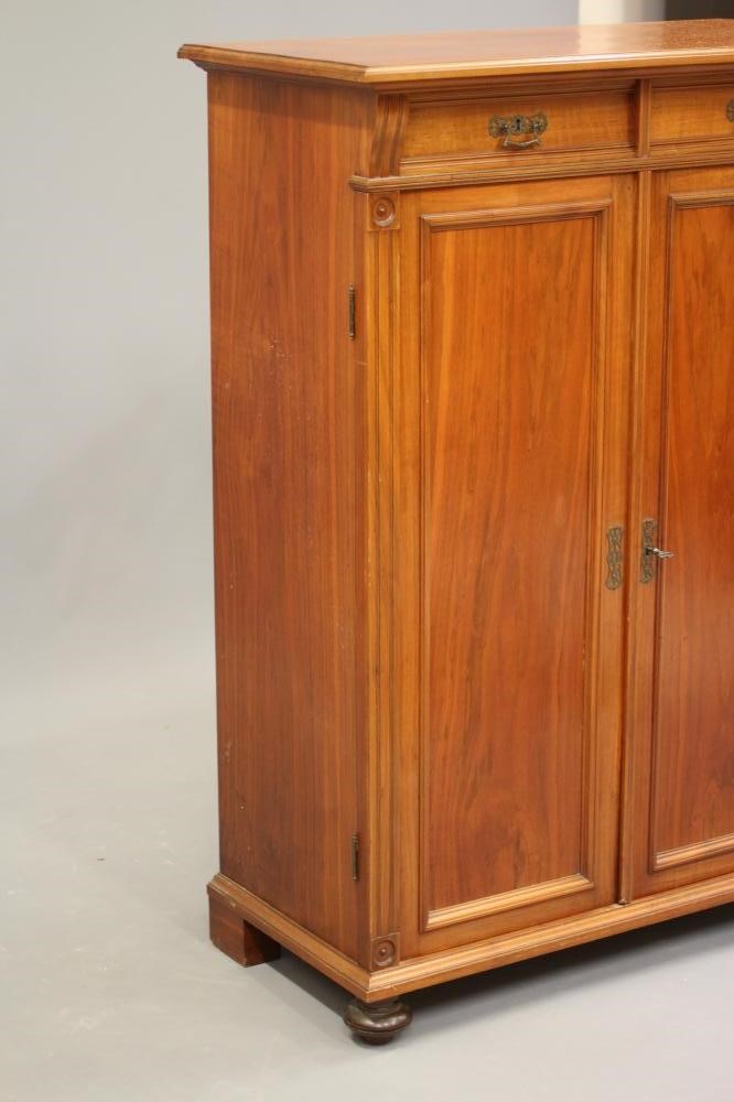 A LATE VICTORIAN WALNUT PIER CABINET in the Aesthetic taste Image
