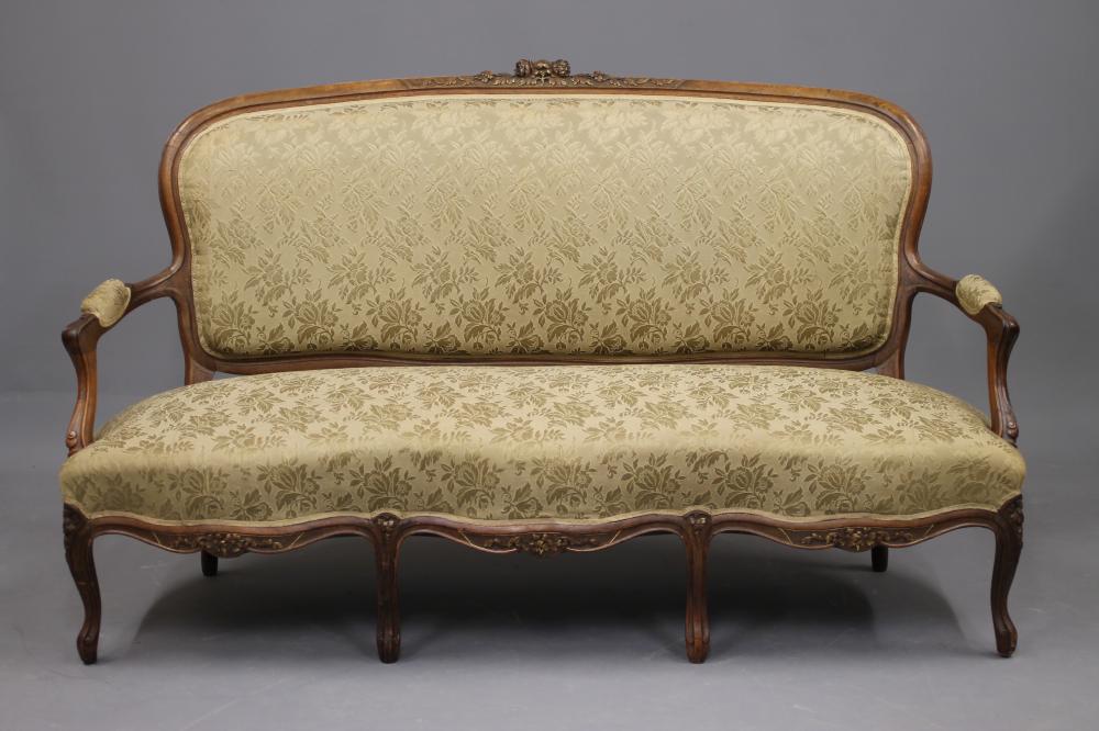 A VICTORIAN WALNUT AND PARCEL GILT SOFA in the Louis XV style Image