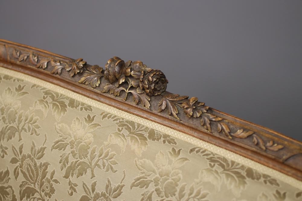 A VICTORIAN WALNUT AND PARCEL GILT SOFA in the Louis XV style Image