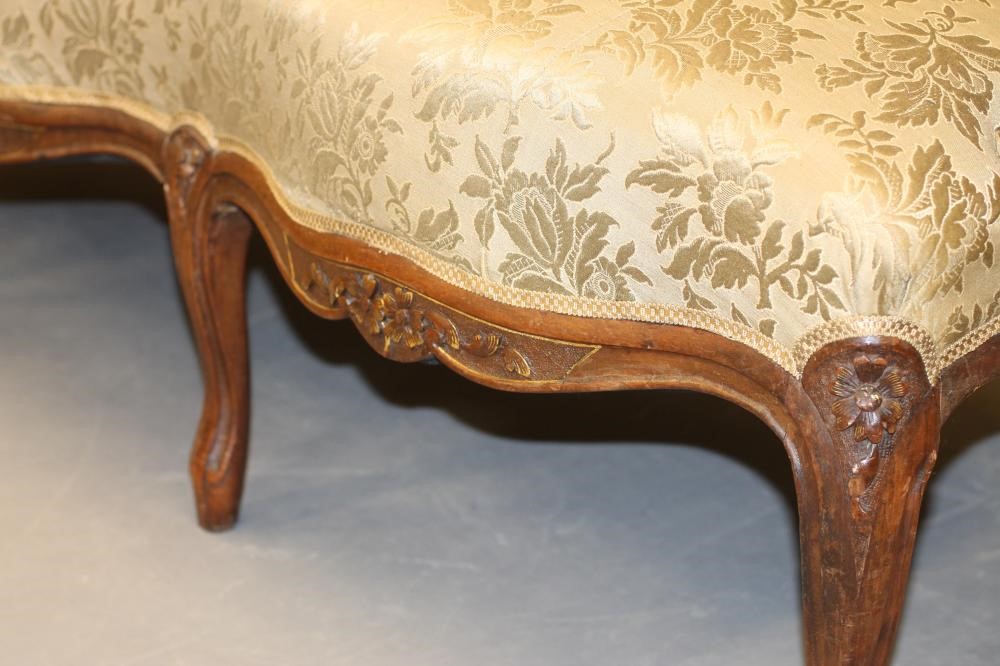 A VICTORIAN WALNUT AND PARCEL GILT SOFA in the Louis XV style Image
