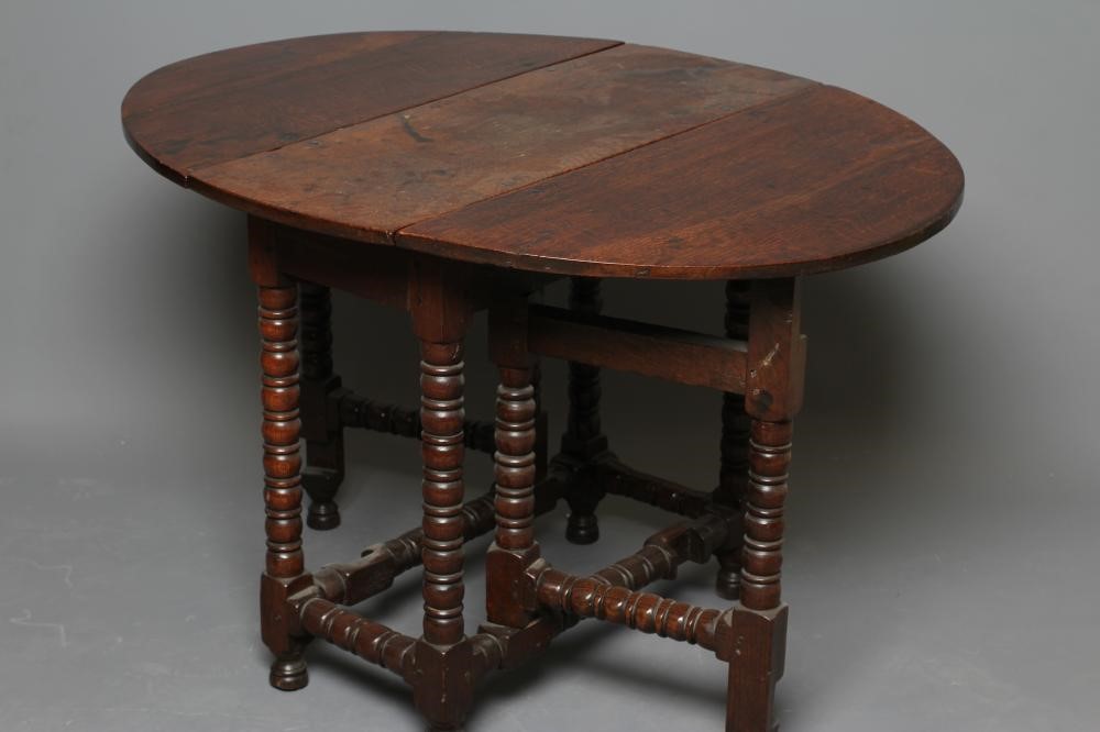A SMALL OAK DROP LEAF TABLE Image