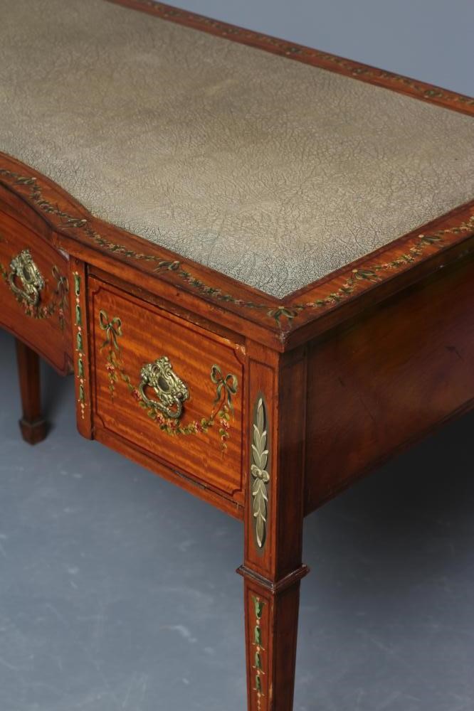 AN EDWARDIAN PAINTED SATINWOOD KNEEHOLE DESK of oblong form with stringing Image