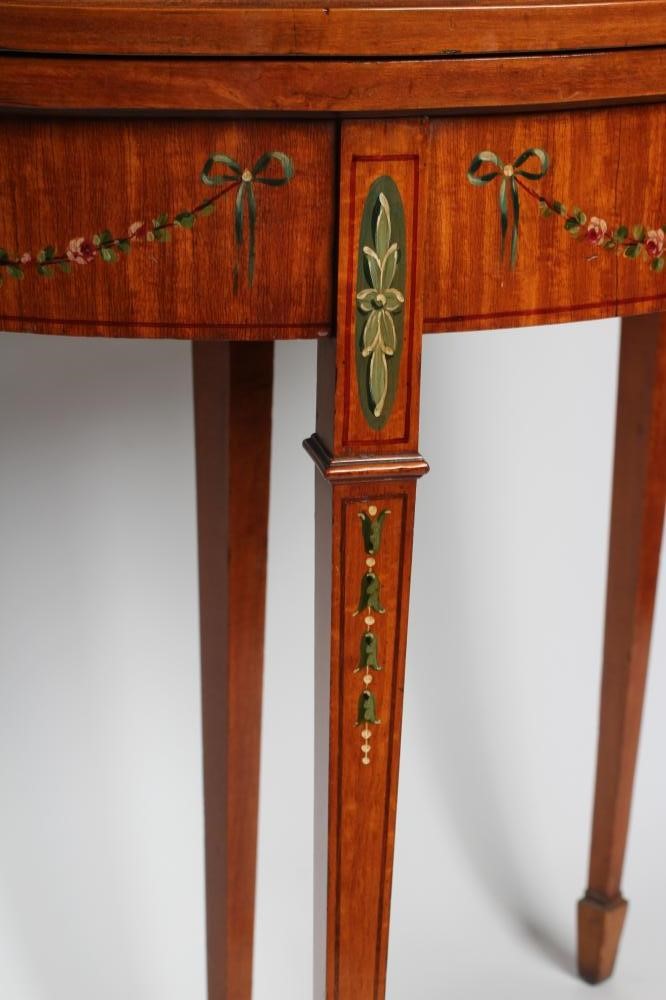 AN EDWARDIAN PAINTED SATINWOOD FOLDING CARD TABLE of demi lune form with stringing Image