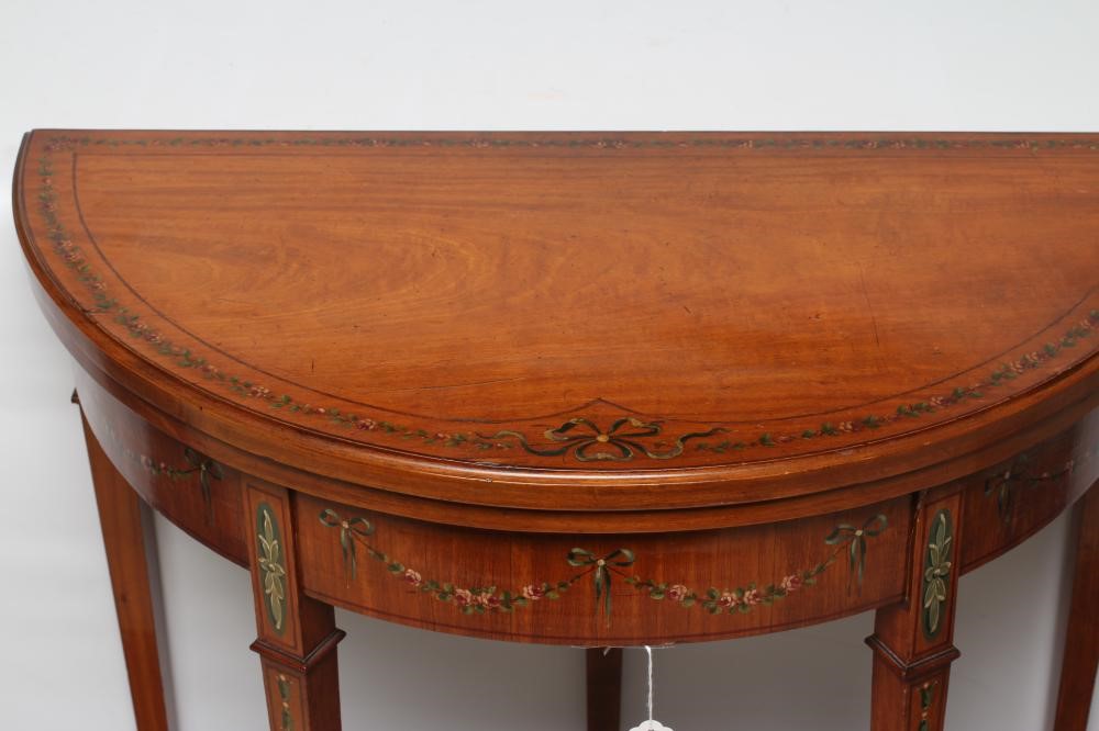 AN EDWARDIAN PAINTED SATINWOOD FOLDING CARD TABLE of demi lune form with stringing Image