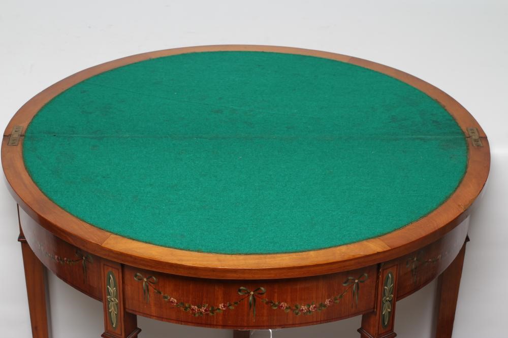 AN EDWARDIAN PAINTED SATINWOOD FOLDING CARD TABLE of demi lune form with stringing Image