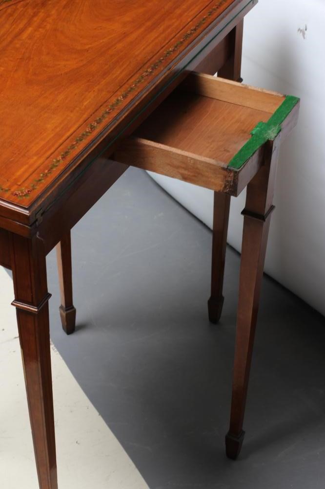 AN EDWARDIAN PAINTED SATINWOOD FOLDING CARD TABLE of demi lune form with stringing Image