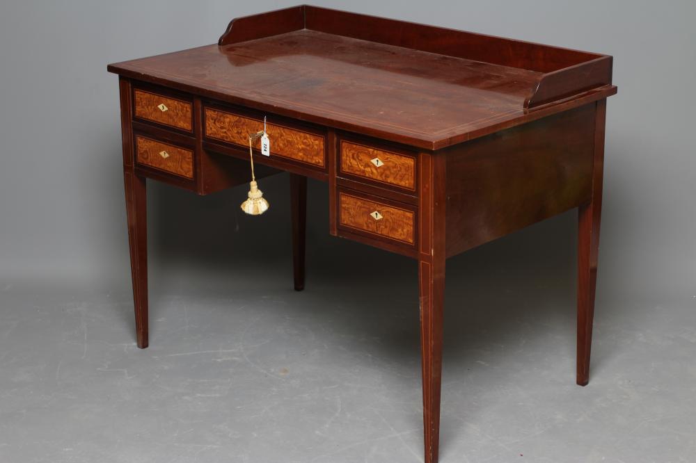 AN EDWARDIAN MAHOGANY KNEEHOLE DRESSING TABLE of oblong form with stringing and three quarter Image