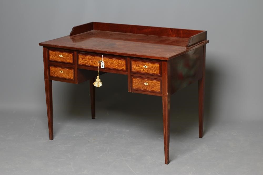 AN EDWARDIAN MAHOGANY KNEEHOLE DRESSING TABLE of oblong form with stringing and three quarter Image