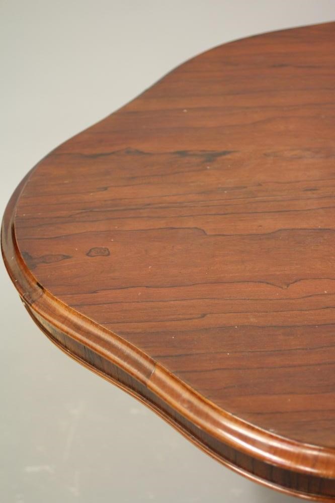 A VICTORIAN ROSEWOOD LOO TABLE of serpentine oval form Image