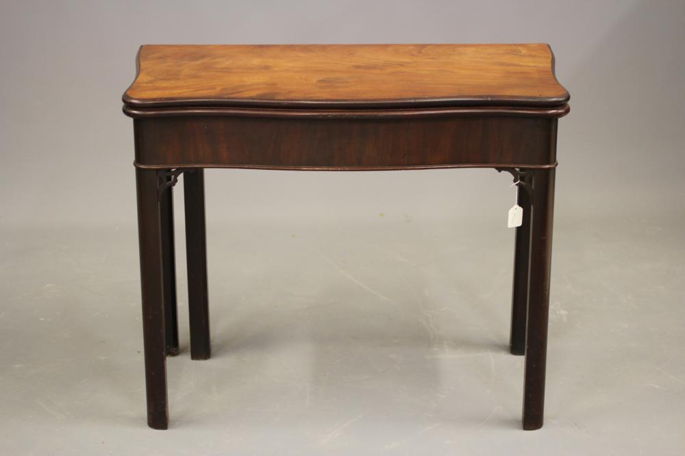 A GEORGE II MAHOGANY FOLDING TEA TABLE of serpentine oblong form Image