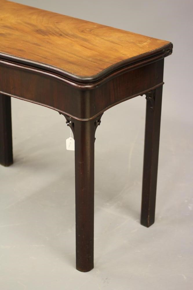 A GEORGE II MAHOGANY FOLDING TEA TABLE of serpentine oblong form Image