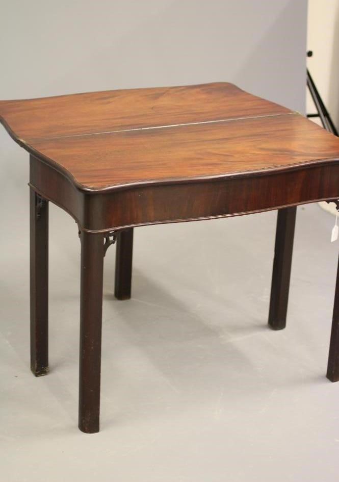 A GEORGE II MAHOGANY FOLDING TEA TABLE of serpentine oblong form Image