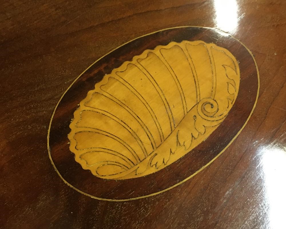 AN EDWARDIAN MAHOGANY OCCASIONAL TABLE of shaped rounded oblong form with stringing Image
