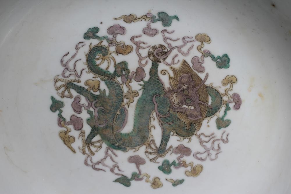 A CHINESE PORCELAIN FAMILLE VERTE BOWL of plain circular form painted with a seated Hotei with Image