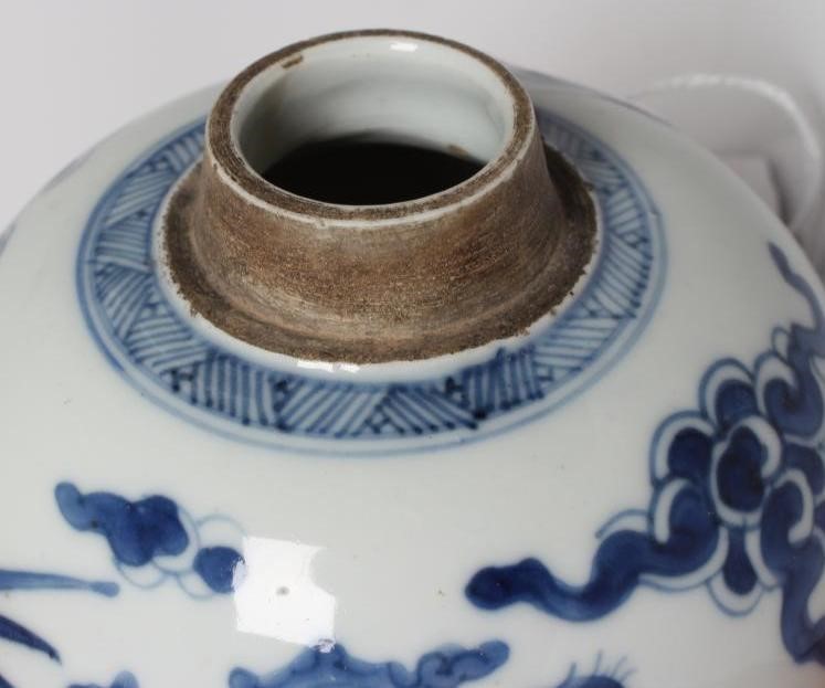 A CHINESE PORCELAIN JAR of ovoid form, painted in underglaze blue with two dragons chasing the Image