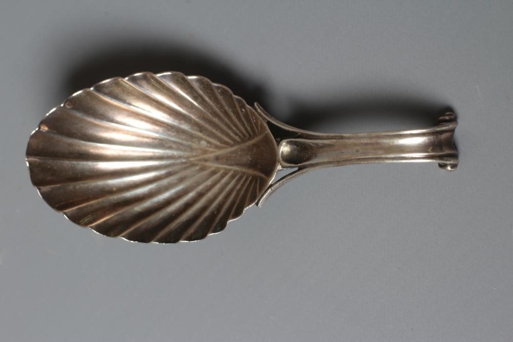 A WILLIAM IV SILVER CADDY SPOON, maker's mark WF, London 1831, the leaf shaped bowl with scroll Image
