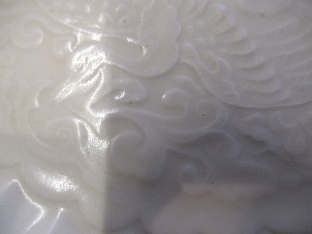 A CHINESE WHITE GLAZED PORCELAIN DISH of fluted circular form centrally carved with a crane in Image