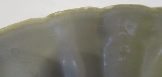 A CHINESE WHITE GLAZED PORCELAIN DISH of fluted circular form centrally carved with a crane in Image