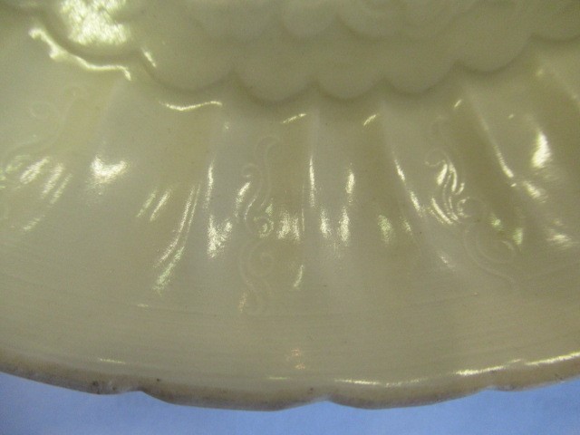 A CHINESE WHITE GLAZED PORCELAIN DISH of fluted circular form centrally carved with a crane in Image