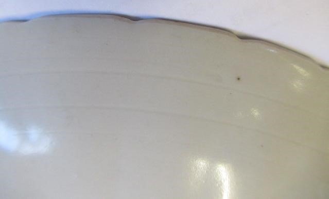 A CHINESE WHITE GLAZED PORCELAIN DISH of fluted circular form centrally carved with a crane in Image