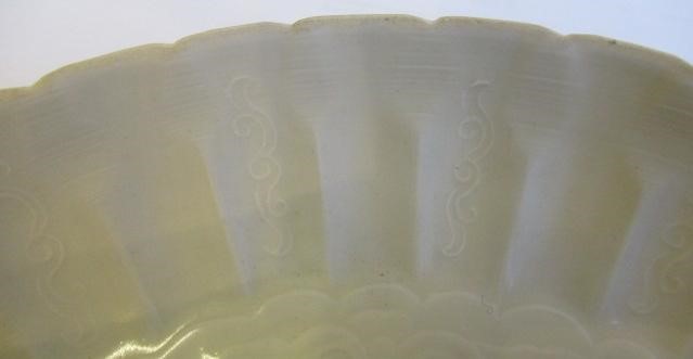 A CHINESE WHITE GLAZED PORCELAIN DISH of fluted circular form centrally carved with a crane in Image