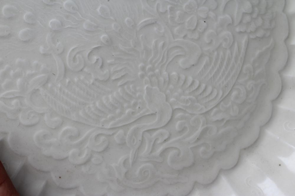 A CHINESE WHITE GLAZED PORCELAIN DISH of fluted circular form centrally carved with a crane in Image