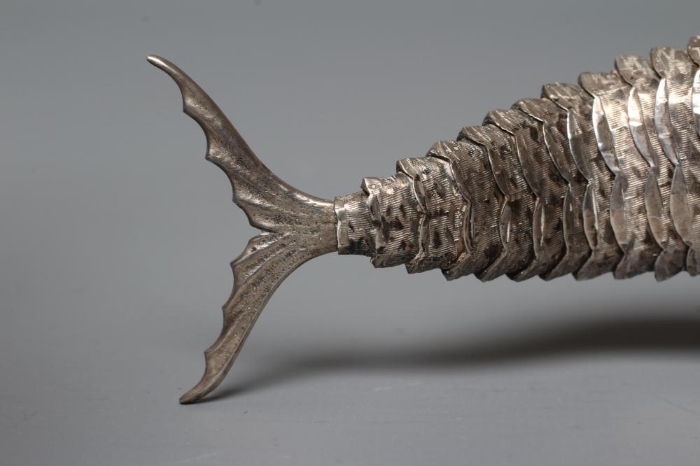 A SPANISH SILVER ARTICULATED SWORDFISH with chased detailing and collet set ruby glass cabochon Image