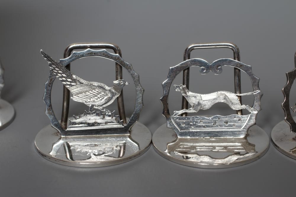 A COMPOSITE SET OF EIGHT SILVER NOVELTY MENU/PLACE CARD HOLDERS Image