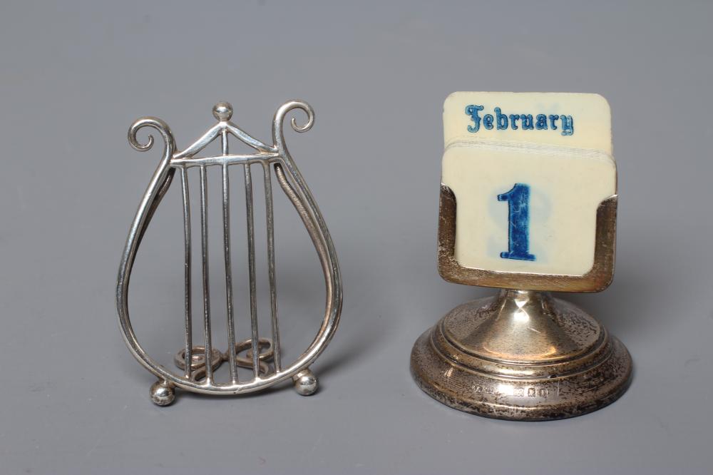 A LATE VICTORIAN SILVER LYRE MENU/PLACE CARD HOLDER by Saunders & Shepherd Image