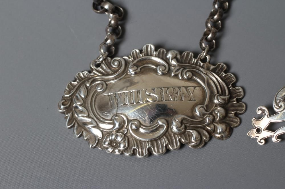 TWO VICTORIAN SILVER BOTTLE LABELS comprising 'Whiskey' by George Unite Image