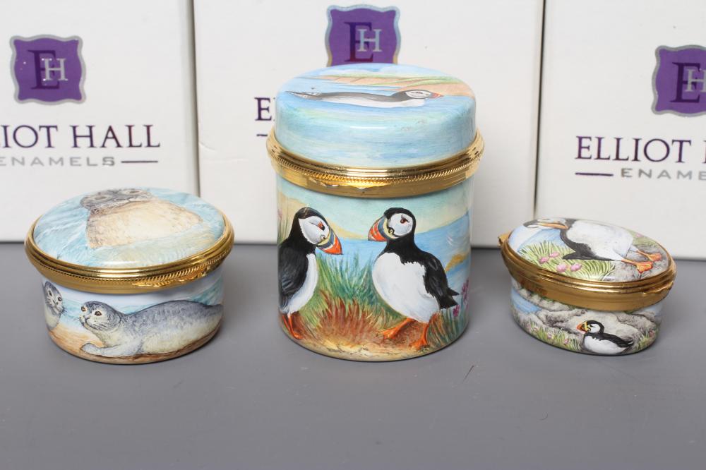 THREE ELLIOT HALL ENAMEL BOXES comprising a cylindrical box painted by Marie Graves with Puffins Image