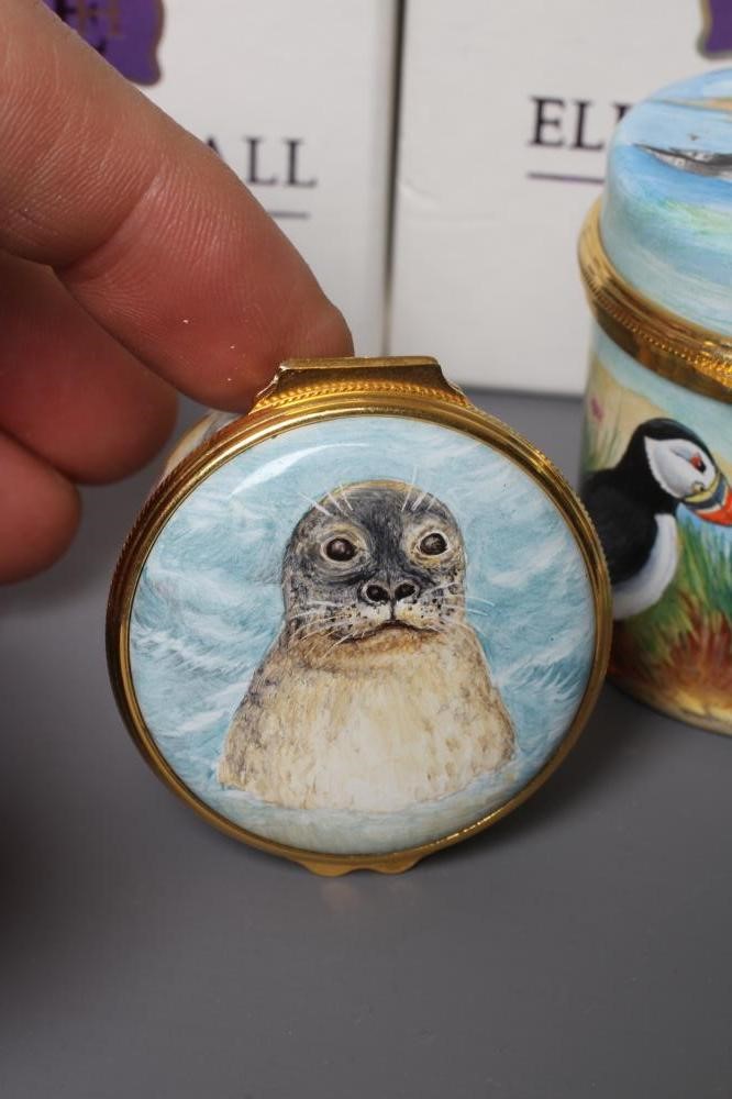 THREE ELLIOT HALL ENAMEL BOXES comprising a cylindrical box painted by Marie Graves with Puffins Image