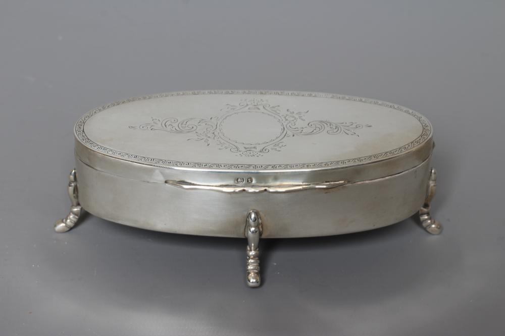 A SILVER OVAL DRESSING TABLE BOX by Hasset & Harper Ltd. Image