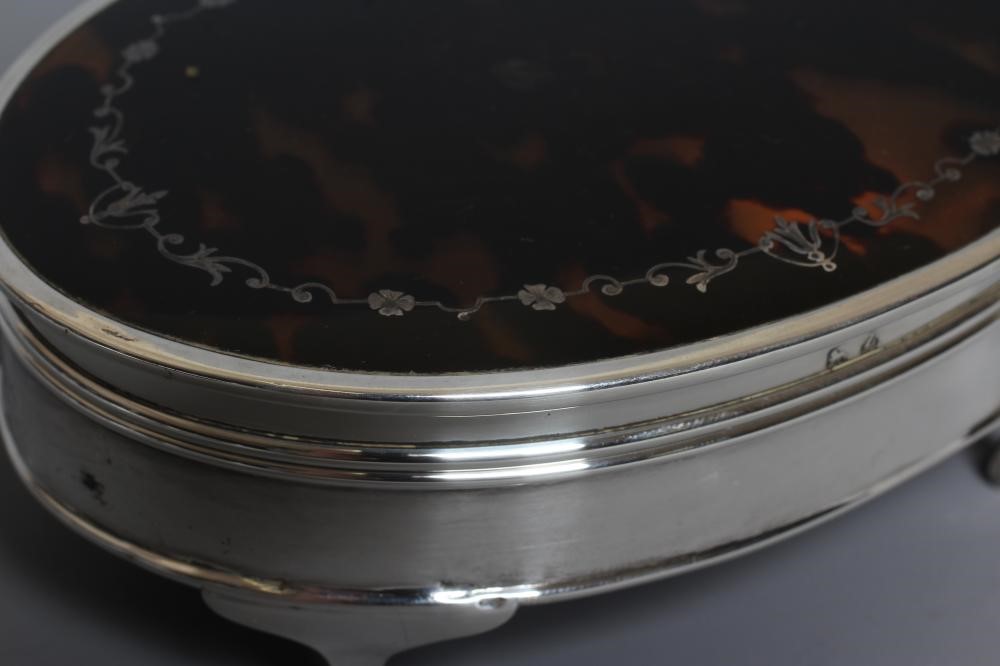 A SILVER OVAL DRESSING TABLE BOX by Adie Bros. Image