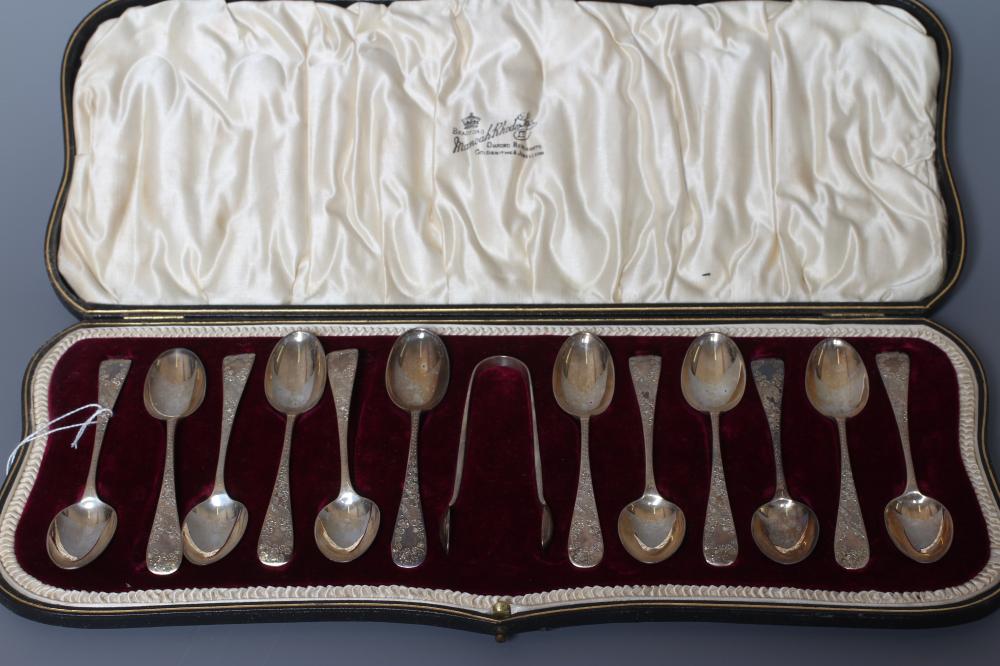 A SET OF TWELVE EDWARDIAN SILVER TEASPOONS AND MATCHING SUGAR TONGS by Wakely & Wheeler Image