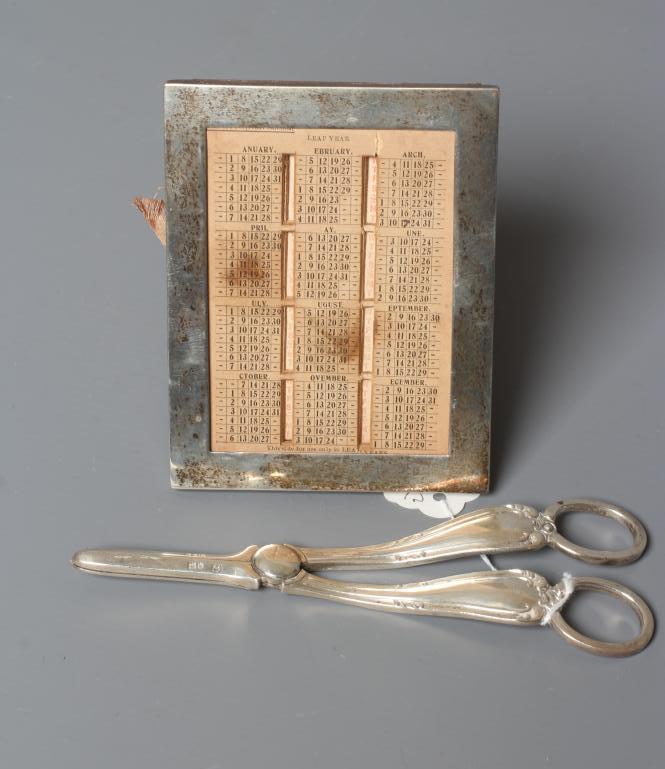 AN EDWARDIAN SILVER EASEL BACK PERPETUAL DESK CALENDAR by William T. Bell Image