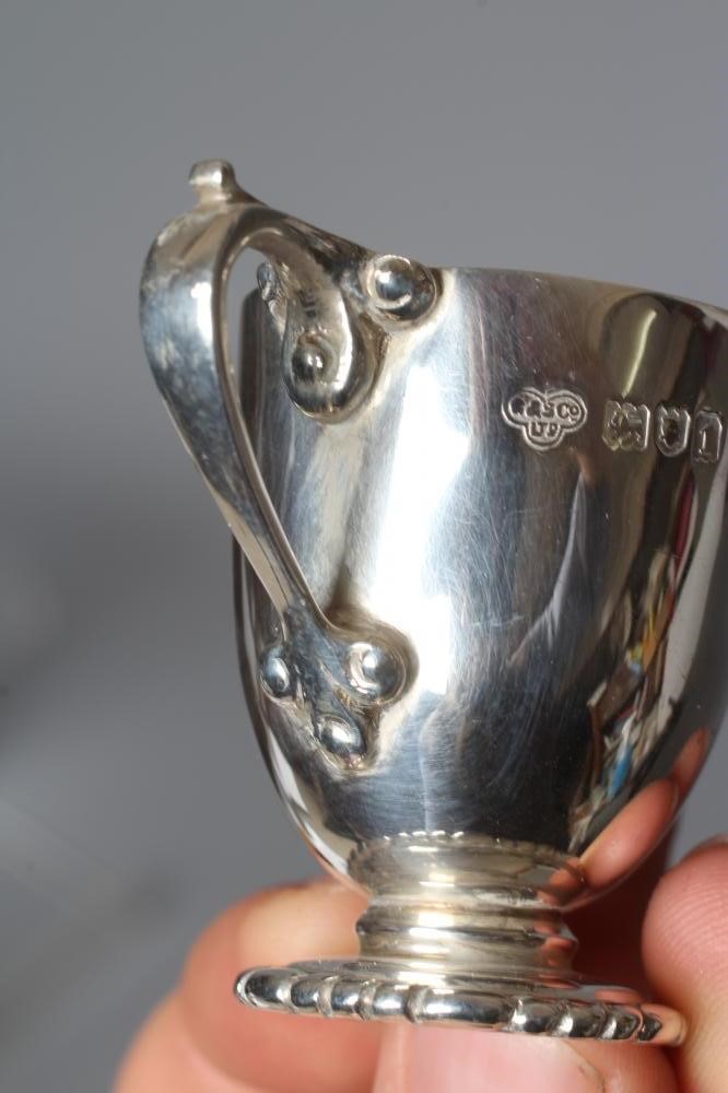 A SET OF SIX EDWARDIAN SILVER MINIATURE TWO HANDLED TROPHY CUPS by Goldsmith's & Silversmith's Co. Image