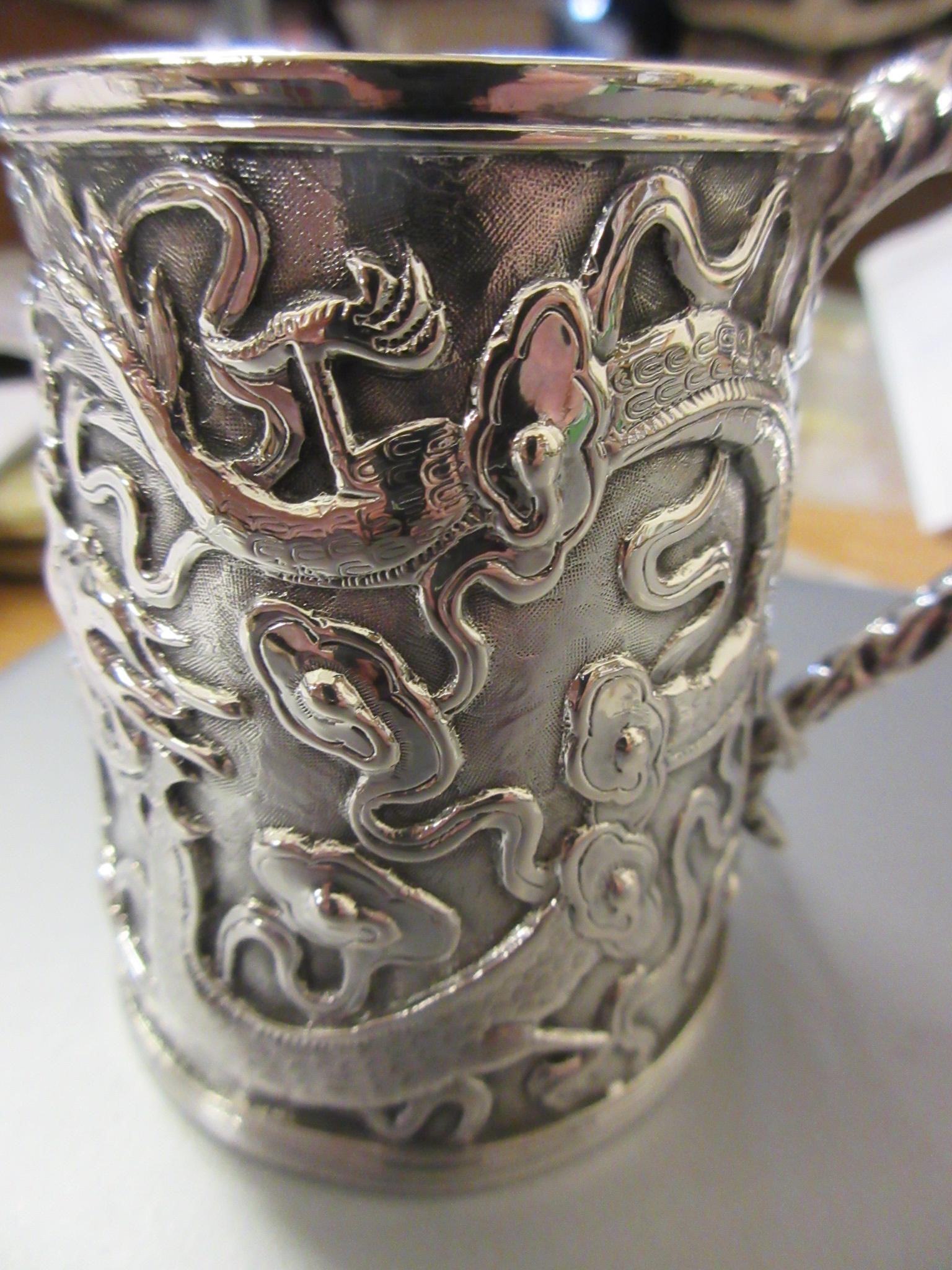 A CHINESE EXPORT SILVER CHRISTENING MUG by Kwong Man Shing (act.1875-1925) Image